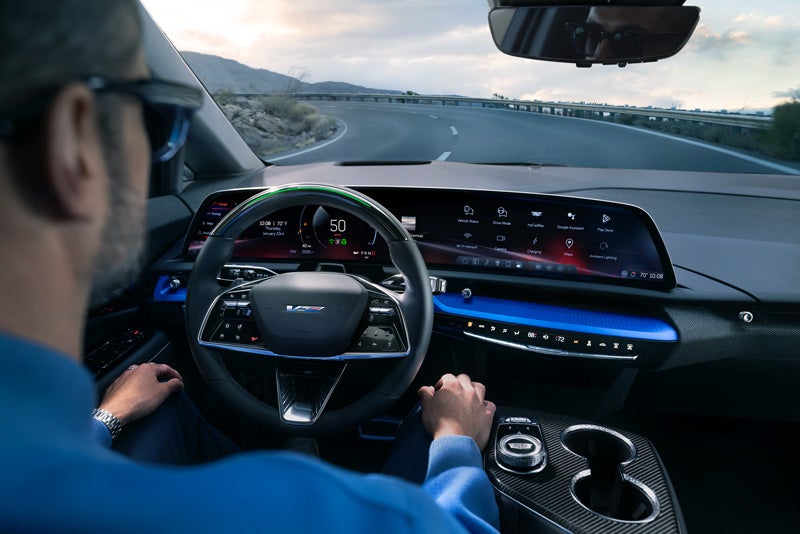 Front View of the 2026 OPTIQ-V Driving Through the Dusk Utilizing its Headlights | Davidson Cadillac of Rome in Rome NY